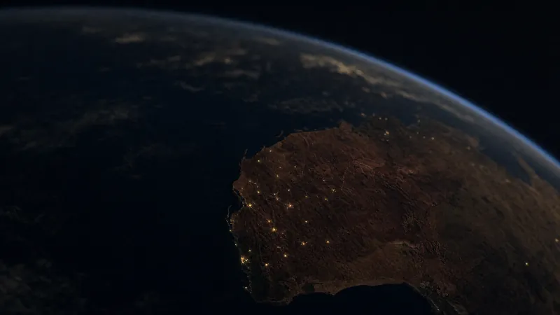 Western Australia seen from orbit at night, lights scattered across the interior and along the coast